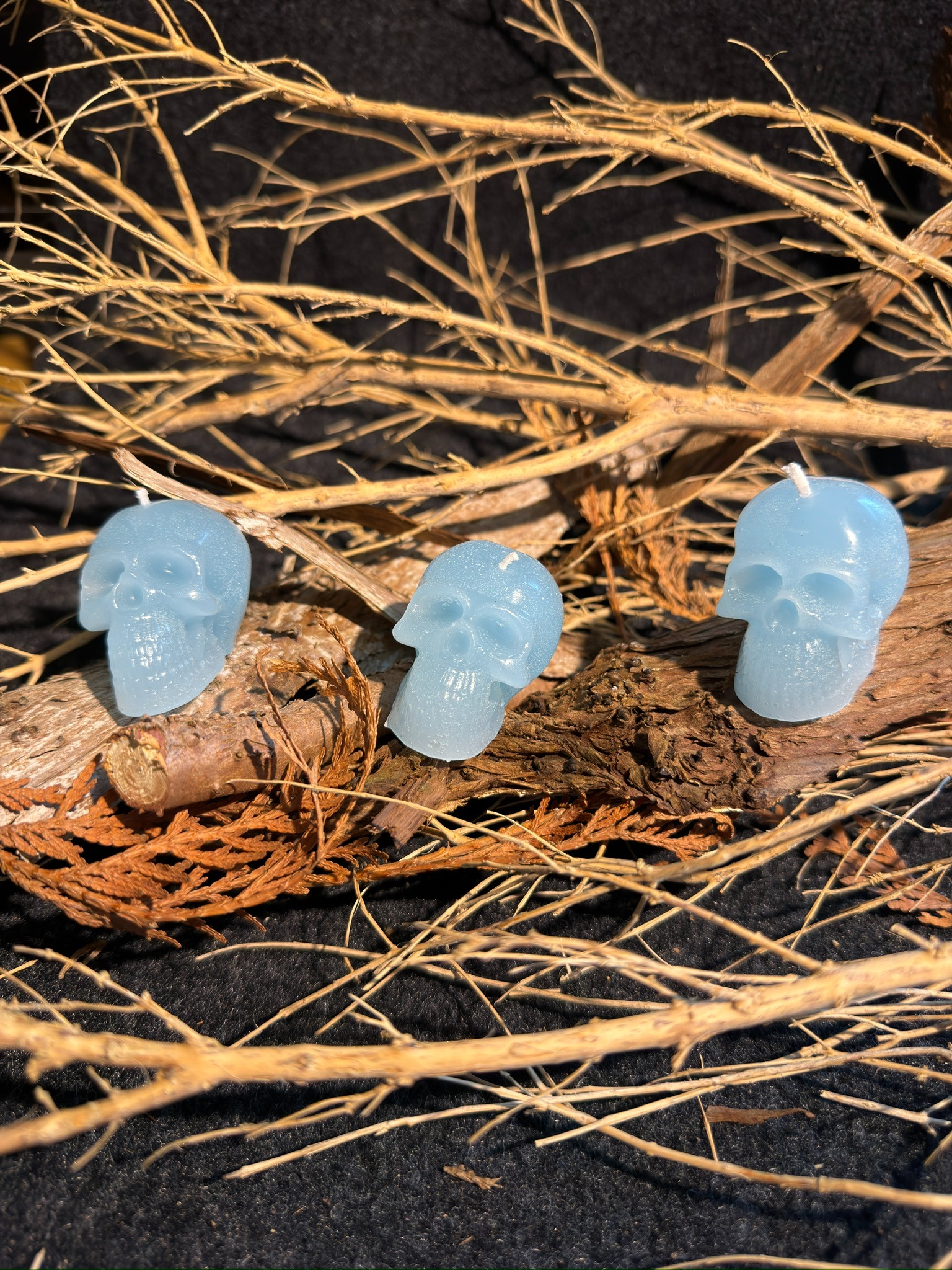 Drei kleine hellblaue Totenkopfkerzen